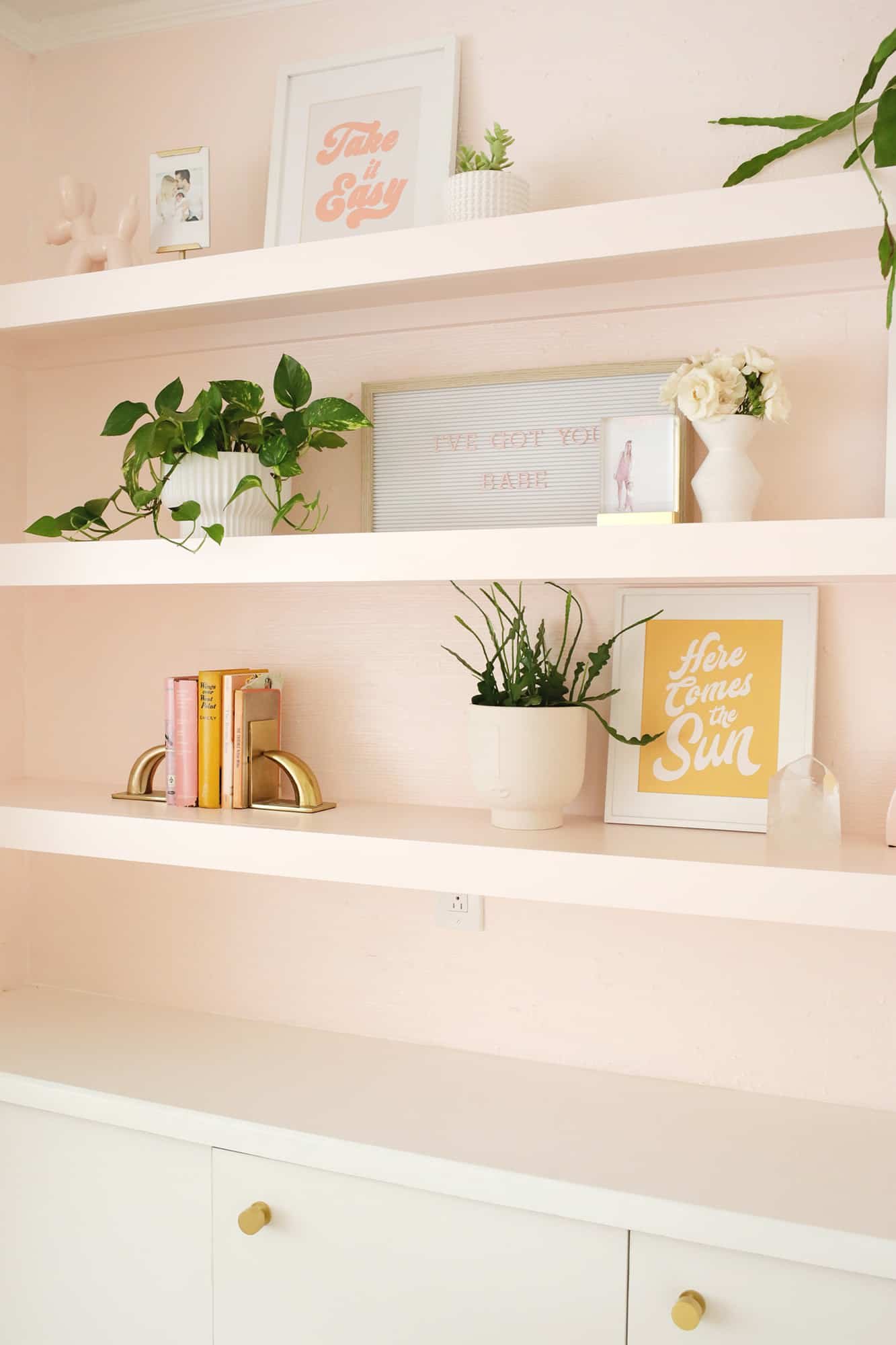 shelf decor on pink shelves