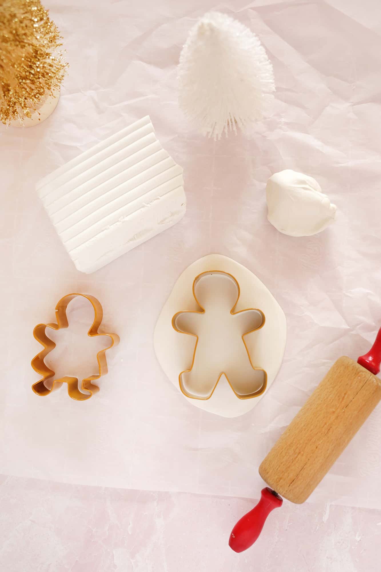 rolled out clay with gingerbread people cookie cutters